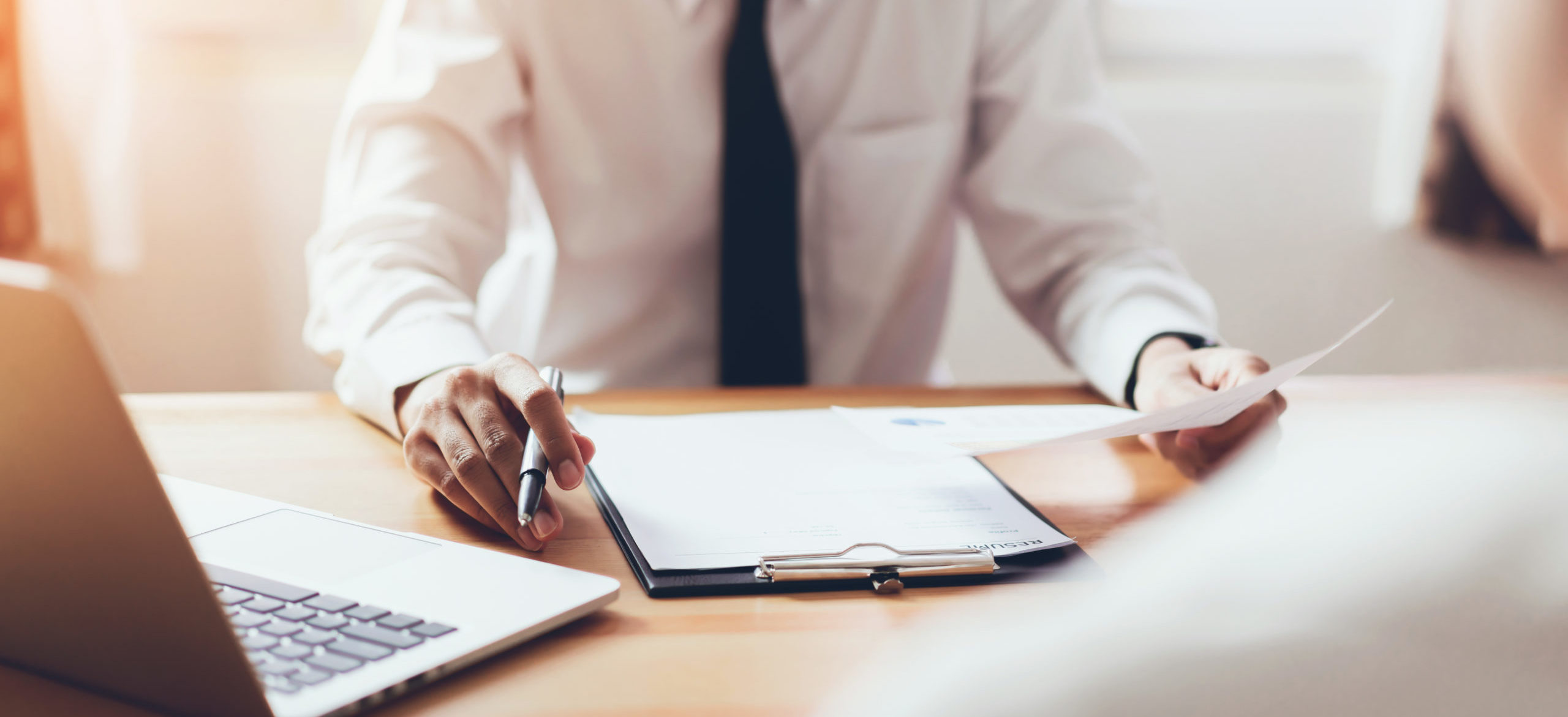 man submit resume to employer to review job application. The concept presents the ability for the company to agree with the position of the job.